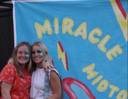 Miracle members with Miracle Midtown banner